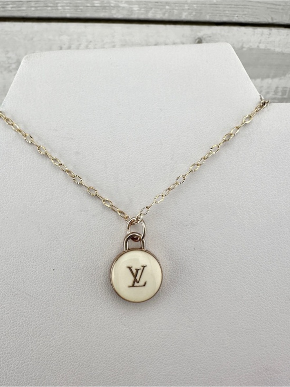 Repurposed necklace with Louis Vuitton round off white zipper pull.